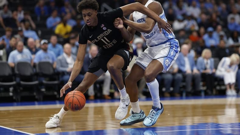 Mar 14, 2024; Washington, D.C., USA; Florida State forward Baba Miller (11) drives to the basket as North Carolina forward Harrison Ingram (55) defends in the first half at Capital One Arena. Mandatory Credit: Geoff Burke-USA TODAY Sports