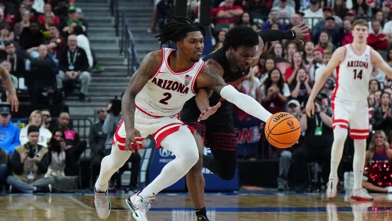 Mar 14, 2024; Las Vegas, NV, USA; Arizona Wildcats guard Caleb Love (2) and Southern California Trojans guard Bronny James (6) battle for the ball in the first half at T-Mobile Arena. Mandatory Credit: Kirby Lee-USA TODAY Sports