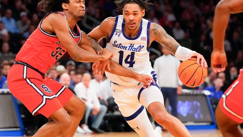 Mar 14, 2024; New York City, NY, USA; Seton Hall Pirates guard Dre Davis (14) drives on St. John's Red Storm forward Glenn Taylor Jr. (35) during the first half at Madison Square Garden. Mandatory Credit: Robert Deutsch-USA TODAY Sports