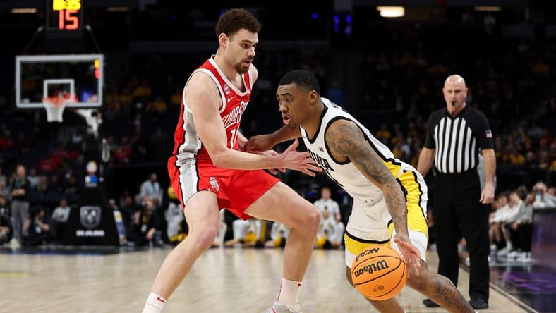 Mar 14, 2024; Minneapolis, MN, USA; Iowa Hawkeyes guard Tony Perkins (11) dribbles around Ohio State Buckeyes forward Jamison Battle (10) during the first half at Target Center. Mandatory Credit: Matt Krohn-USA TODAY Sports