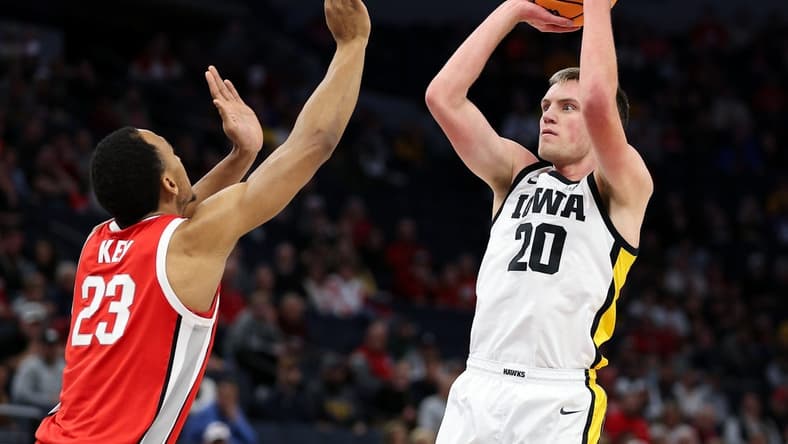 Mar 14, 2024; Minneapolis, MN, USA; Iowa Hawkeyes forward Payton Sandfort (20) shoots as Ohio State Buckeyes forward Zed Key (23) defends during the first half at Target Center. Mandatory Credit: Matt Krohn-USA TODAY Sports