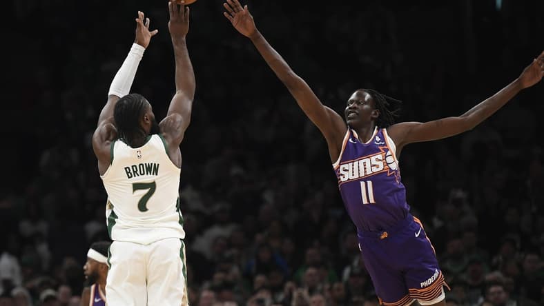 Mar 14, 2024; Boston, Massachusetts, USA; Boston Celtics guard Jaylen Brown (7) shoots the ball over Phoenix Suns center Bol Bol (11) during the first half at TD Garden. Mandatory Credit: Bob DeChiara-USA TODAY Sports