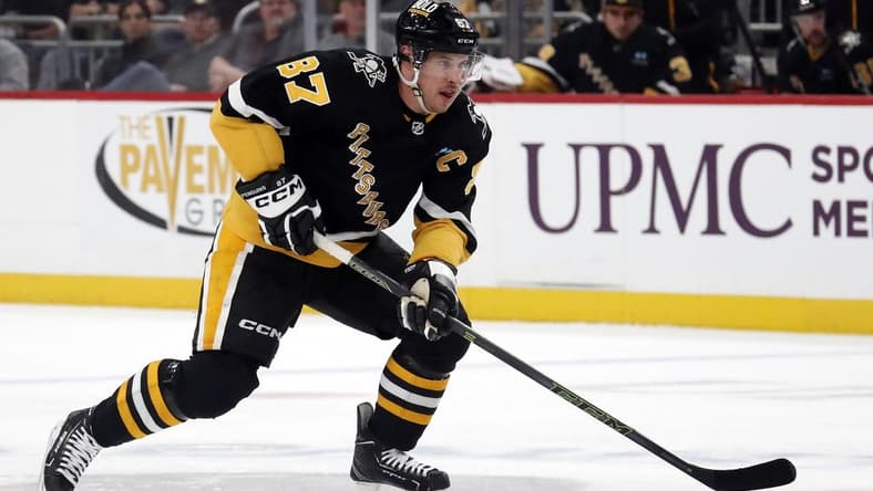Mar 14, 2024; Pittsburgh, Pennsylvania, USA; Pittsburgh Penguins center Sidney Crosby (87) moves the puck up ice against the San Jose Sharks during the first period at PPG Paints Arena. Mandatory Credit: Charles LeClaire-USA TODAY Sports