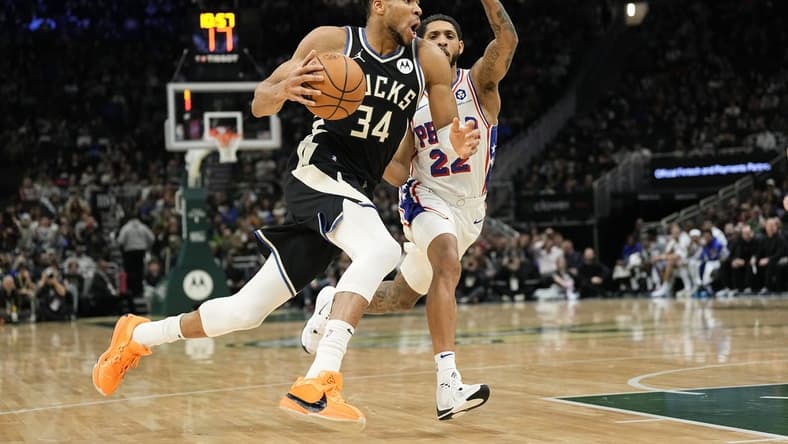 Mar 14, 2024; Milwaukee, Wisconsin, USA;  Milwaukee Bucks forward Giannis Antetokounmpo (34) drives for the basket in front of Philadelphia 76ers guard Cameron Payne (22) during the second quarter at Fiserv Forum. Mandatory Credit: Jeff Hanisch-USA TODAY Sports