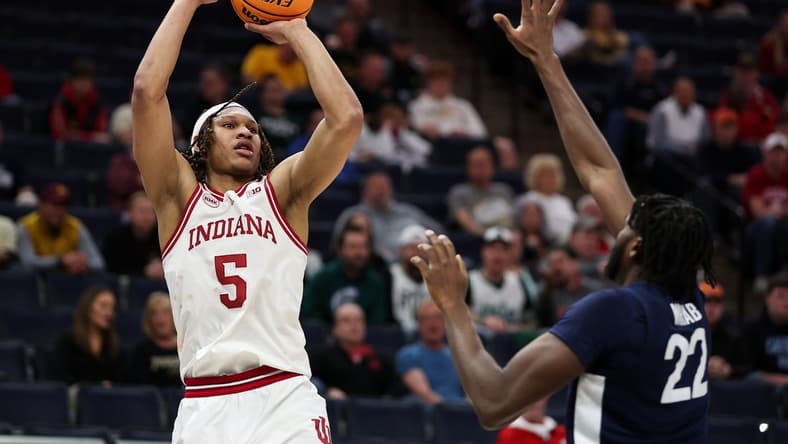 Mar 14, 2024; Minneapolis, MN, USA; Indiana Hoosiers forward Malik Reneau (5) shoots as Penn State Nittany Lions forward Qudus Wahab (22) defends during the first half at Target Center. Mandatory Credit: Matt Krohn-USA TODAY Sports