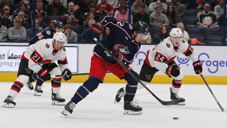 Mar 14, 2024; Columbus, Ohio, USA; Columbus Blue Jackets center Alexander Texier (42) grabs a loose puck as Ottawa Senators defenseman Jacob Bernard-Docker (24) trails the play during the third period at Nationwide Arena. Mandatory Credit: Russell LaBounty-USA TODAY Sports