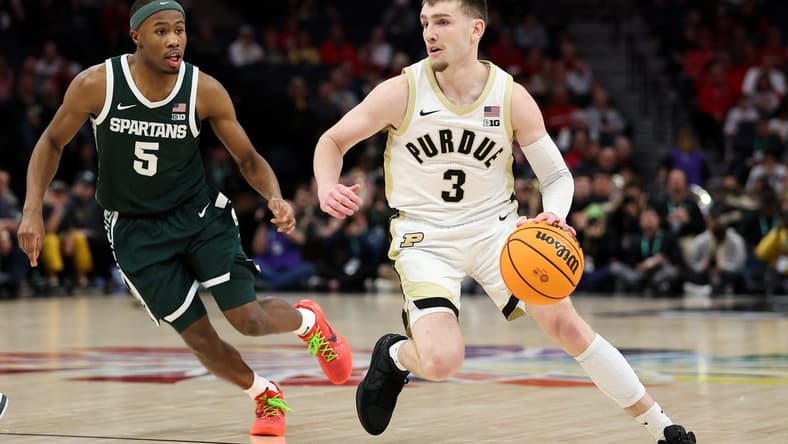 Mar 15, 2024; Minneapolis, MN, USA; Purdue Boilermakers guard Braden Smith (3) works around Michigan State Spartans guard Tre Holloman (5) during the first half at Target Center. Mandatory Credit: Matt Krohn-USA TODAY Sports