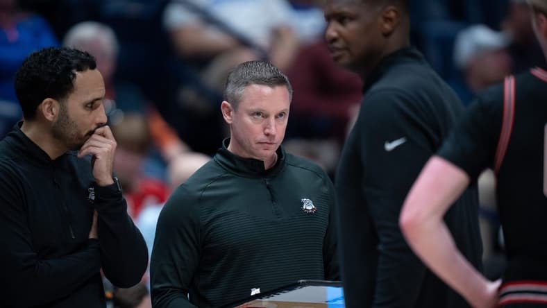 Georgia Bulldogs head coach Mike White confers with his coaches during their second round game of the SEC Men's Basketball Tournament against Florida at Bridgestone Arena in Nashville, Tenn., Thursday, March 14, 2024.