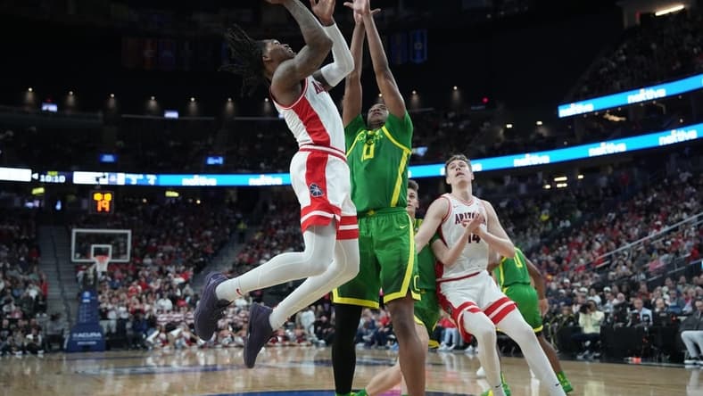 Mar 15, 2024; Las Vegas, NV, USA; Arizona Wildcats guard Caleb Love (2) shoots the ball against Oregon Ducks forward Kwame Evans Jr. (10) in the first half at T-Mobile Arena. Mandatory Credit: Kirby Lee-USA TODAY Sports