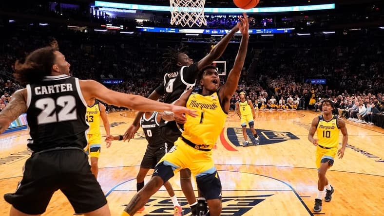 Mar 15, 2024; New York City, NY, USA; Marquette Golden Eagles guard Kam Jones (1) shoots past Providence Friars guard Garwey Dual (3) during the first half at Madison Square Garden. Mandatory Credit: Robert Deutsch-USA TODAY Sports