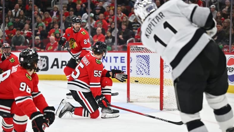 Mar 15, 2024; Chicago, Illinois, USA; Los Angeles Kings forward Anze Kopitar (11) scores into an nearly empty net in the first period against the Chicago Blackhawks at United Center. Mandatory Credit: Jamie Sabau-USA TODAY Sports