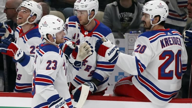 Mar 16, 2024; Pittsburgh, Pennsylvania, USA;  New York Rangers defenseman Adam Fox (23) celebrates his goal with the Rangers bench against the Pittsburgh Penguins during the first period at PPG Paints Arena. Mandatory Credit: Charles LeClaire-USA TODAY Sports