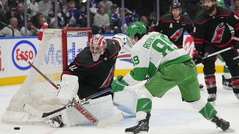 Mar 16, 2024; Toronto, Ontario, CAN; Toronto Maple Leafs forward Nicholas Robertson (89) and Carolina Hurricanes goaltender Pyotr Kochetkov (52) battle for the puck during the first period at Scotiabank Arena. Mandatory Credit: John E. Sokolowski-USA TODAY Sports