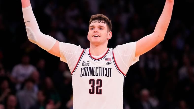 Mar 16, 2024; New York City, NY, USA;  Connecticut Huskies center Donovan Clingan (32) celebrates as the clock winds down against Marquette Golden Eagles in the second half at Madison Square Garden. Mandatory Credit: Robert Deutsch-USA TODAY Sports