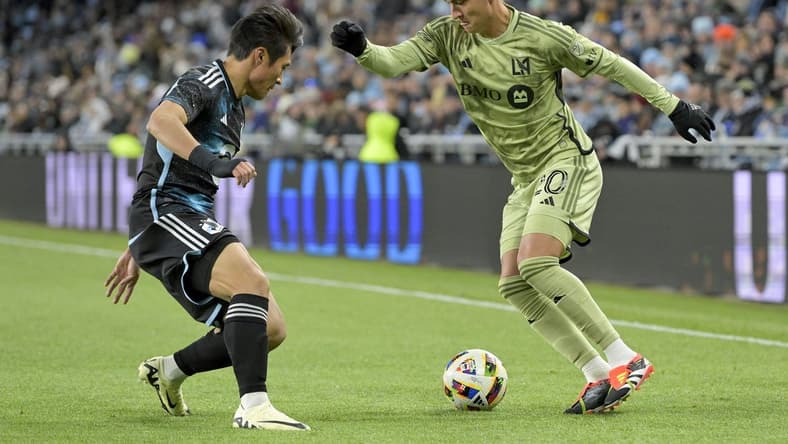 Mar 16, 2024; Saint Paul, Minnesota, USA;  Los Angeles FC midfielder Eduard Atuesta (20) controls the ball as Minnesota United FC forward Jeong Sang-Bin (11) defends during the first half at Allianz Field. Mandatory Credit: Nick Wosika-USA TODAY Sports