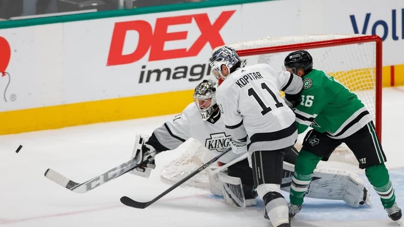 Mar 16, 2024; Dallas, Texas, USA; Los Angeles Kings goaltender David Rittich (31) fights off a shot with center Anze Kopitar (11) and Dallas Stars center Joe Pavelski (16) in front of his goal during the first period at American Airlines Center. Mandatory Credit: Andrew Dieb-USA TODAY Sports