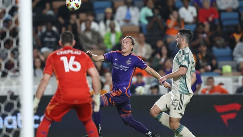 Mar 16, 2024; Houston, Texas, USA; Houston Dynamo FC midfielder Griffin Dorsey (25) runs after the ball against Portland Timbers defender Eric Miller (15) in the first half at Shell Energy Stadium. Mandatory Credit: Troy Taormina-USA TODAY Sports