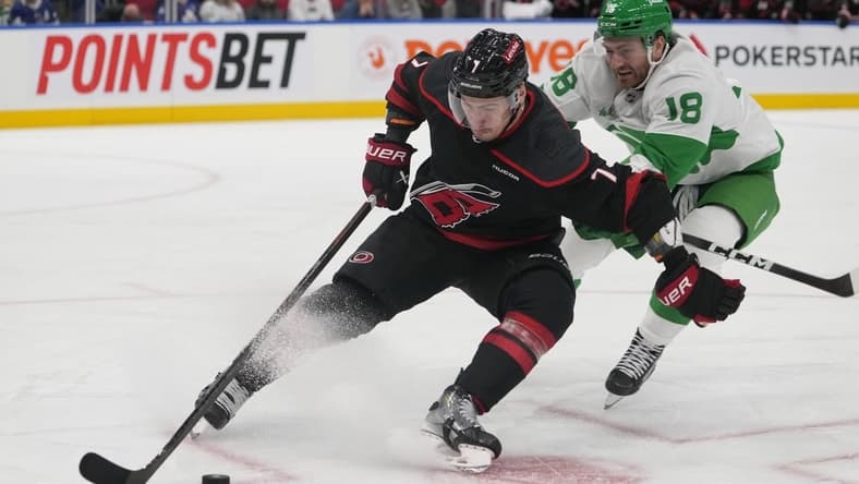 Mar 16, 2024; Toronto, Ontario, CAN; Carolina Hurricanes defenseman Dmitry Orlov (7) controls the puck against Toronto Maple Leafs forward Noah Gregor (18) during the third period at Scotiabank Arena. Mandatory Credit: John E. Sokolowski-USA TODAY Sports