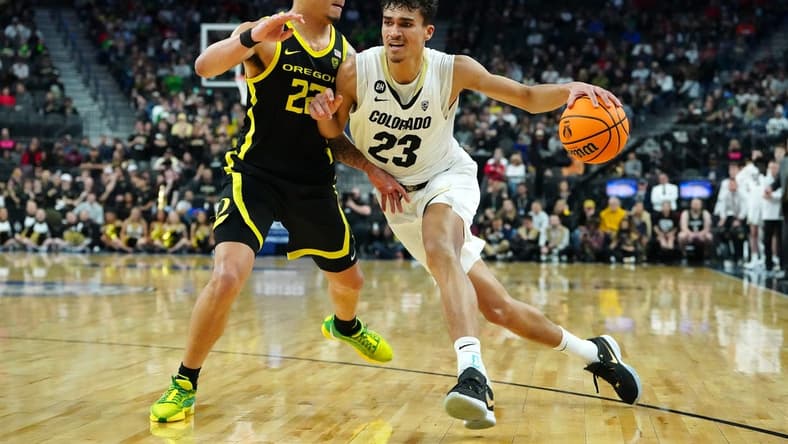 Mar 16, 2024; Las Vegas, NV, USA; Colorado Buffaloes forward Tristan da Silva (23) dribbles against Oregon Ducks guard Jadrian Tracey (22) during the first half at T-Mobile Arena. Mandatory Credit: Stephen R. Sylvanie-USA TODAY Sports