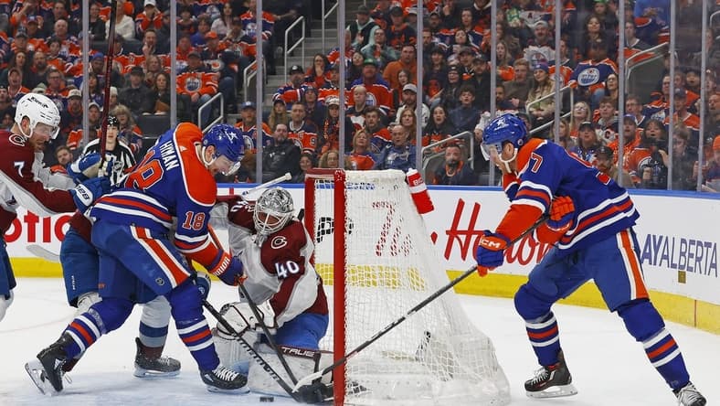 Mar 16, 2024; Edmonton, Alberta, CAN; Edmonton Oilers forward Connor McDavid (97) and forward Zach Hyman (18) try to jam a loose puck past Colorado Avalanche goaltender Alexander Georgiev (40) during the first period at Rogers Place. Mandatory Credit: Perry Nelson-USA TODAY Sports