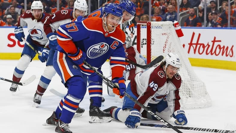 Mar 16, 2024; Edmonton, Alberta, CAN; Edmonton Oilers forward Connor McDavid (97) looks to make a pass in front of Colorado Avalanche defensemen Sam Girard (49) during the first period at Rogers Place. Mandatory Credit: Perry Nelson-USA TODAY Sports