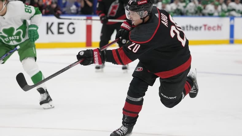 Mar 16, 2024; Toronto, Ontario, CAN; Carolina Hurricanes forward Sebastian Aho (20) shoots the puck against the Toronto Maple Leafs during the second period at Scotiabank Arena. Mandatory Credit: John E. Sokolowski-USA TODAY Sports