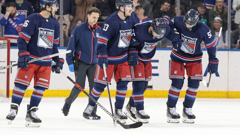 Mar 17, 2024; New York, New York, USA; New York Rangers defenseman Ryan Lindgren (55) is helped off the ice by teammates after an injury during the second period against the New York Islanders at Madison Square Garden. Mandatory Credit: Vincent Carchietta-USA TODAY Sports