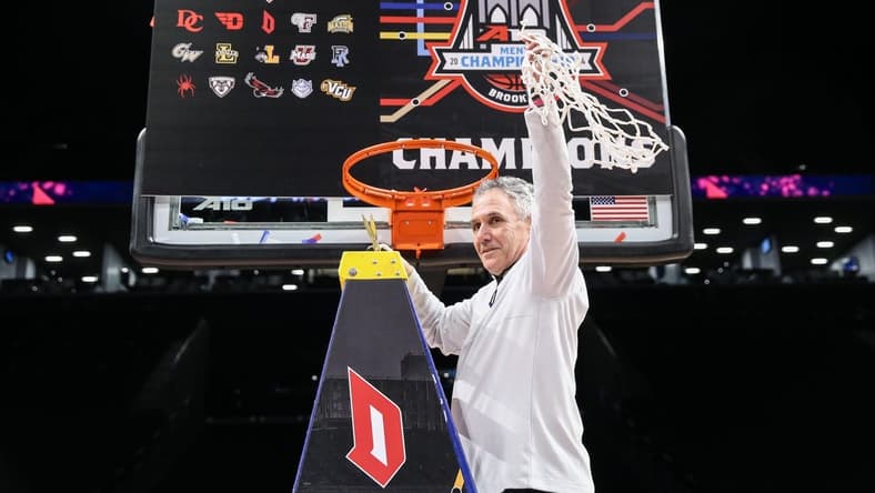Mar 17, 2024; Brooklyn, NY, USA; Duquesne Dukes head coach Keith Dambrot cuts the nets after winning the Atlantic 10 Tournament Championship at Barclays Center. Mandatory Credit: Wendell Cruz-USA TODAY Sports