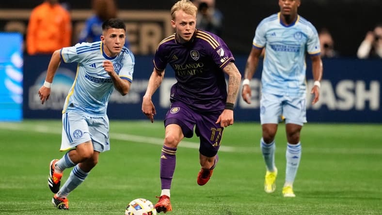 Mar 17, 2024; Atlanta, Georgia, USA; Orlando City midfielder Dagur Thorhallsson (17) dribbles the ball as Atlanta United midfielder Thiago Almada (10) pursues during the first half at Mercedes-Benz Stadium. Mandatory Credit: Dale Zanine-USA TODAY Sports