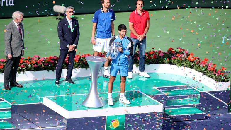 Carlos Alcaraz holds the trophy after defeating Daniil Medvedev 7-6(5), 6-1in the BNP Paribas Open championship match at the Indian Wells Tennis Garden in Indian Wells, Calif., on Sunday, March 17, 2024.