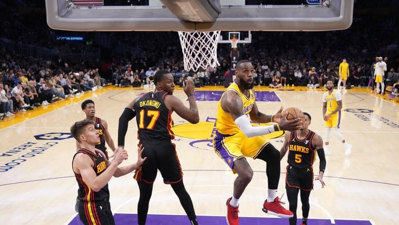 Mar 18, 2024; Los Angeles, California, USA; Los Angeles Lakers forward LeBron James (23) shoots the ball against Atlanta Hawks forward Onyeka Okongwu (17) in the second half at Crypto.com Arena. Mandatory Credit: Kirby Lee-USA TODAY Sports