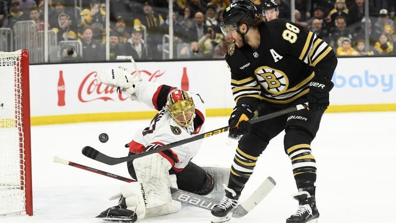 Mar 19, 2024; Boston, Massachusetts, USA;  Boston Bruins right wing David Pastrnak (88) scores a goal past Ottawa Senators goaltender Joonas Korpisalo (70) during the first period at TD Garden. Mandatory Credit: Bob DeChiara-USA TODAY Sports