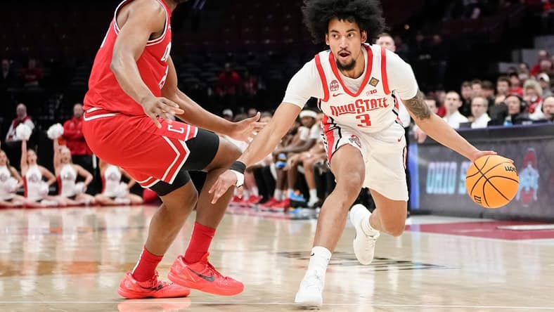 Mar 19, 2024; Columbus, OH, USA; Ohio State Buckeyes guard Taison Chatman (3) dribbles around Cornell Big Red forward Guy Ragland Jr. (21) during the first half of the NIT basketball game at Value City Arena.