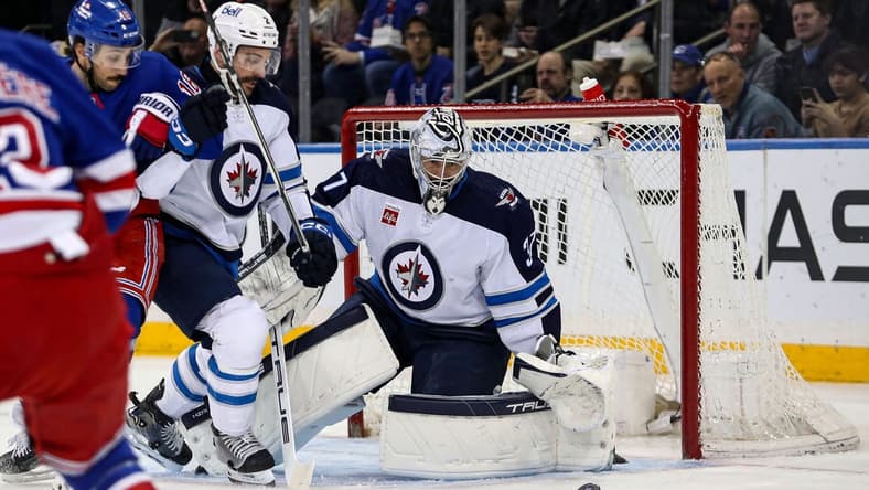 Mar 19, 2024; New York, New York, USA; Winnipeg Jets goalie Connor Hellebuyck (37) makes a save against the New York Rangers during the first period at Madison Square Garden. Mandatory Credit: Danny Wild-USA TODAY Sports