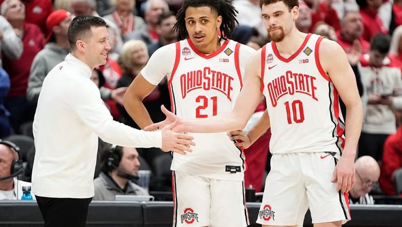 Mar 19, 2024; Columbus, OH, USA; Ohio State Buckeyes head coach Jake Diebler high fives Ohio State Buckeyes forward Jamison Battle (10) and forward Devin Royal (21) during the second half of the NIT basketball game against the Cornell Big Red at Value City Arena. Ohio State won 88-83.