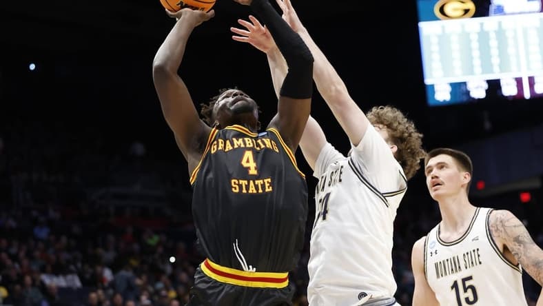 Mar 20, 2024; Dayton, OH, USA; Grambling State Tigers forward Antwan Burnett (4) goes to the basket defended by Montana State Bobcats guard Jed Miller (24) in the first half  at UD Arena. Mandatory Credit: Rick Osentoski-USA TODAY Sports