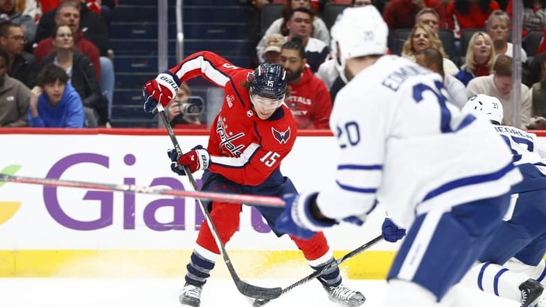 Mar 20, 2024; Washington, District of Columbia, USA; Washington Capitals left wing Sonny Milano (15) controls the puck in front of Toronto Maple Leafs defenseman Joel Edmundson (20) during the first period at Capital One Arena. Mandatory Credit: Amber Searls-USA TODAY Sports