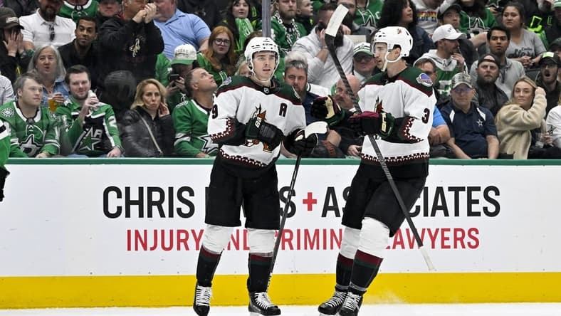 Mar 20, 2024; Dallas, Texas, USA; Arizona Coyotes right wing Clayton Keller (9) and defenseman Josh Brown (3) celebrates a goal scored by Keller against the Dallas Stars during the first period at the American Airlines Center. Mandatory Credit: Jerome Miron-USA TODAY Sports