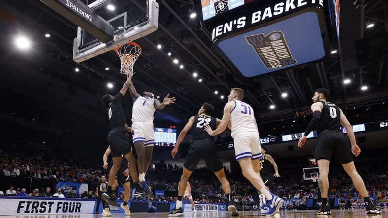 Mar 20, 2024; Dayton, OH, USA; Boise State Broncos forward O'Mar Stanley (1) goes to the basket defended by Colorado Buffaloes forward Cody Williams (10) in the first half at UD Arena. Mandatory Credit: Rick Osentoski-USA TODAY Sports