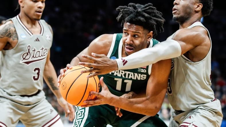 Michigan State guard A.J. Hoggard (11) looks to pass against Mississippi State guard Josh Hubbard (13) during the first half of NCAA tournament West Region first round at Spectrum Center in Charlotte, N.C. on Thursday, March 21, 2024.