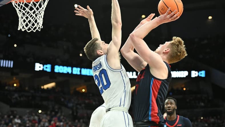 Mar 21, 2024; Omaha, NE, USA; Duquesne Dukes forward Jakub Necas (7) shoots against Brigham Young Cougars guard Spencer Johnson (20) in the first half during the first round of the NCAA Tournament at CHI Health Center Omaha. Mandatory Credit: Steven Branscombe-USA TODAY Sports