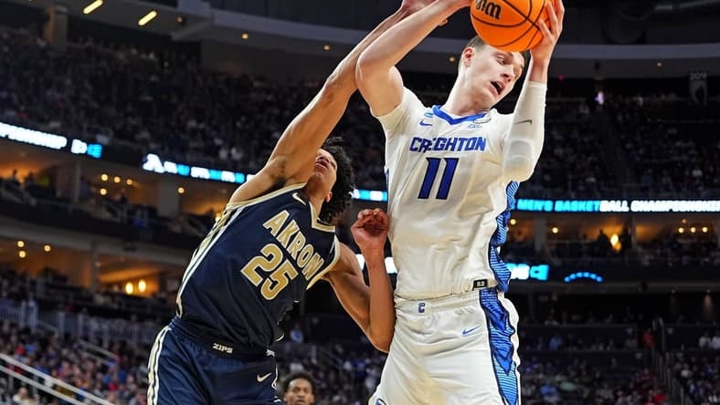Mar 21, 2024; Pittsburgh, PA, USA; Creighton Bluejays center Ryan Kalkbrenner (11) grabs a rebound against Akron Zips forward Enrique Freeman (25) during the second half in the first round of the 2024 NCAA Tournament at PPG Paints Arena. Mandatory Credit: Gregory Fisher-USA TODAY Sports