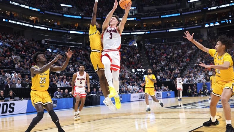 Mar 21, 2024; Salt Lake City, UT, USA;  Arizona Wildcats guard Pelle Larsson (3) drives to the net against  Long Beach State 49ers forward Amari Stroud (1) during the first half in the first round of the 2024 NCAA Tournament at Vivint Smart Home Arena-Delta Center. Mandatory Credit: Rob Gray-USA TODAY Sports