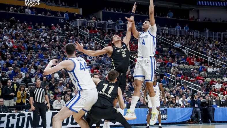 Mar 21, 2024; Pittsburgh, PA, USA; Kentucky Wildcats forward Tre Mitchell (4) jumps to shoot the ball while Oakland Golden Grizzlies forward Chris Conway (2) attempts to block in the first round of the 2024 NCAA Tournament at PPG Paints Arena. Mandatory Credit: Charles LeClaire-USA TODAY Sports