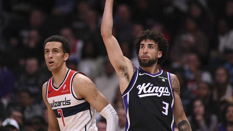 Mar 21, 2024; Washington, District of Columbia, USA;  Sacramento Kings guard Chris Duarte (3) follows through on a three point basket as Washington Wizards forward Patrick Baldwin Jr. (7) looks on during the first half at Capital One Arena. Mandatory Credit: Tommy Gilligan-USA TODAY Sports
