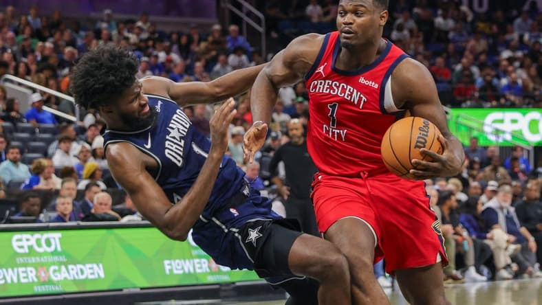 Mar 21, 2024; Orlando, Florida, USA; New Orleans Pelicans forward Zion Williamson (1) is fouled by Orlando Magic forward Jonathan Isaac (1) during the second half at KIA Center. Mandatory Credit: Mike Watters-USA TODAY Sports