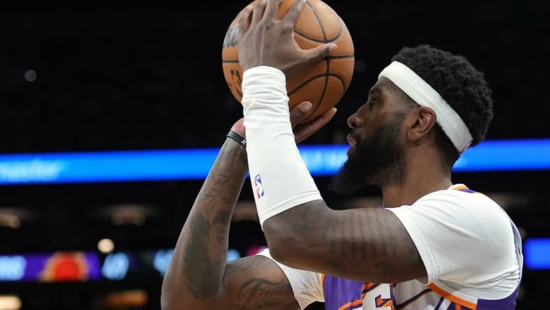 Mar 21, 2024; Phoenix, Arizona, USA; Phoenix Suns forward Royce O'Neale (00) shoots against the Atlanta Hawks during the first half at Footprint Center. Mandatory Credit: Joe Camporeale-USA TODAY Sports