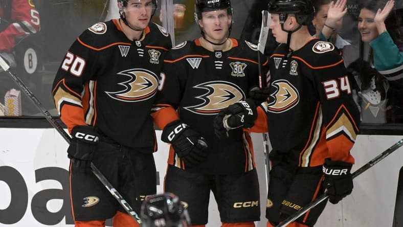 Mar 21, 2024; Anaheim, California, USA;  Anaheim Ducks right wing Brett Leason (20) is congratulated by center Ben Meyers (39) and defenseman Pavel Mintyukov (34) after scoring a goal in the second period against the Chicago Blackhawks at Honda Center. Mandatory Credit: Jayne Kamin-Oncea-USA TODAY Sports