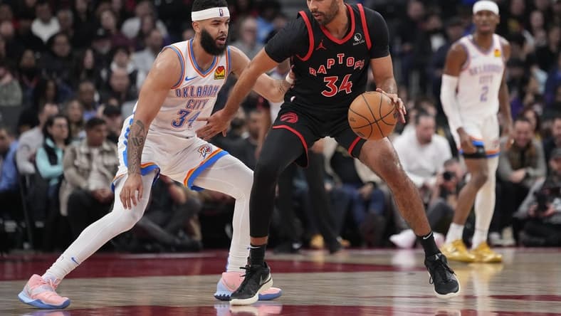Mar 22, 2024; Toronto, Ontario, CAN; Toronto Raptors forward Jontay Porter (34) controls the ball against Oklahoma City Thunder forward Kenrich Williams (34) during the first half at Scotiabank Arena. Mandatory Credit: John E. Sokolowski-USA TODAY Sports