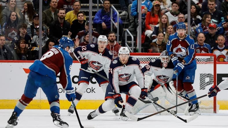 Mar 22, 2024; Denver, Colorado, USA; Colorado Avalanche defenseman Cale Makar (8) controls the puck as Columbus Blue Jackets right wing Mathieu Olivier (24) and defenseman Jake Bean (22) and goaltender Elvis Merzlikins (90) and right wing Valeri Nichushkin (13) look on in the first period at Ball Arena. Mandatory Credit: Isaiah J. Downing-USA TODAY Sports